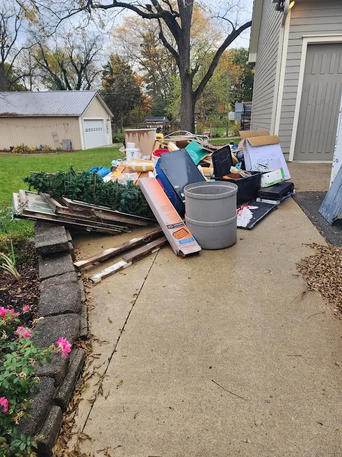 Dumpster being loaded with debris for 10 Yard Dumpster Rental in Waterville